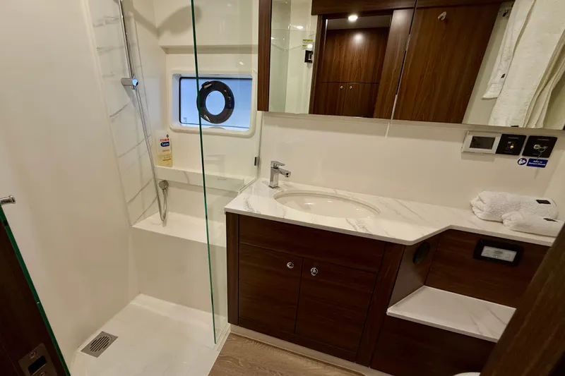  Yacht Photos Pics Luxurious bathroom in 2023 Maritimo M600 yacht with modern fixtures and elegant wood cabinetry.