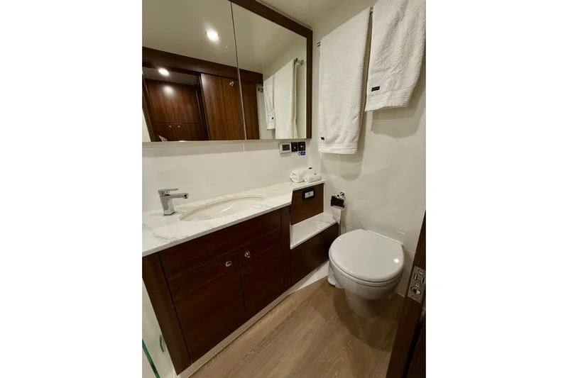  Yacht Photos Pics Luxurious bathroom in 2023 Maritimo M600 yacht with modern fixtures and elegant wood cabinetry.
