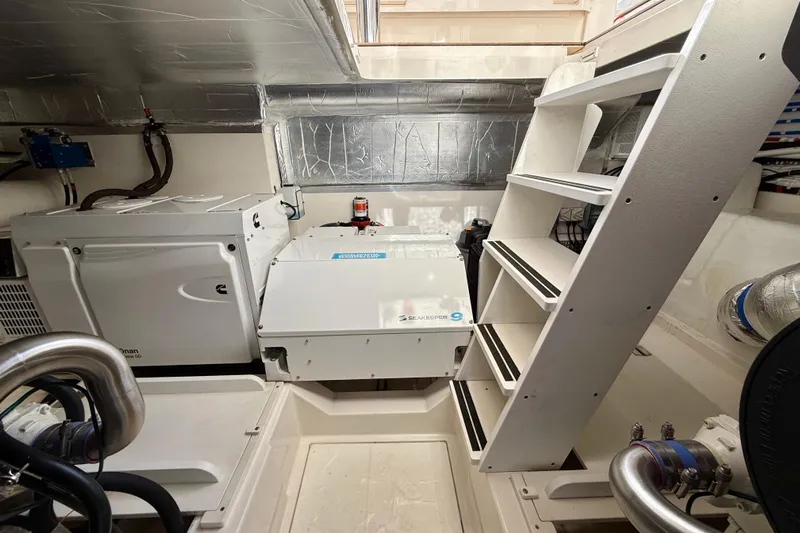  Yacht Photos Pics Engine room of 2023 Maritimo M600 yacht with equipment and access ladder.