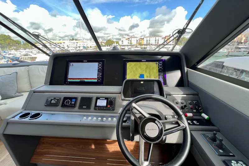  Yacht Photos Pics 2023 Maritimo M600 yacht helm with advanced navigation displays and controls.