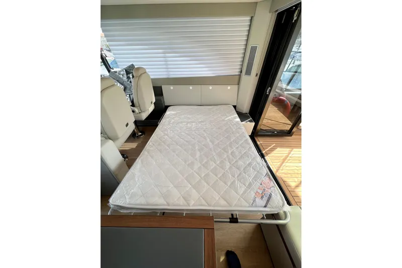  Yacht Photos Pics 2023 Maritimo M600 interior with convertible bed setup, showcasing luxury yacht design.