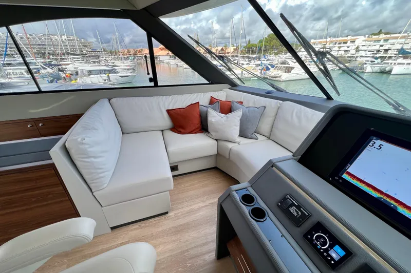  Yacht Photos Pics Luxurious interior of 2023 Maritimo M600 yacht with plush seating and modern dashboard.