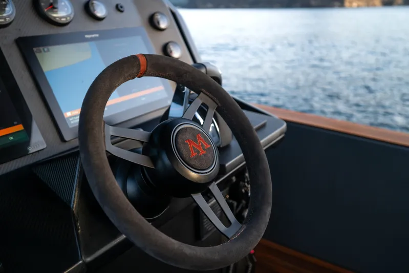 Maxim Yachts | Max43 Race Yacht Photos Pics Steering wheel of 2025 Maxim Yachts 43, overlooking serene waters.
