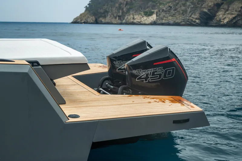 Maxim Yachts | Max43 Race Yacht Photos Pics Sleek Maxim Yachts 43 (2025) with powerful outboard engines, docked by scenic coastline.