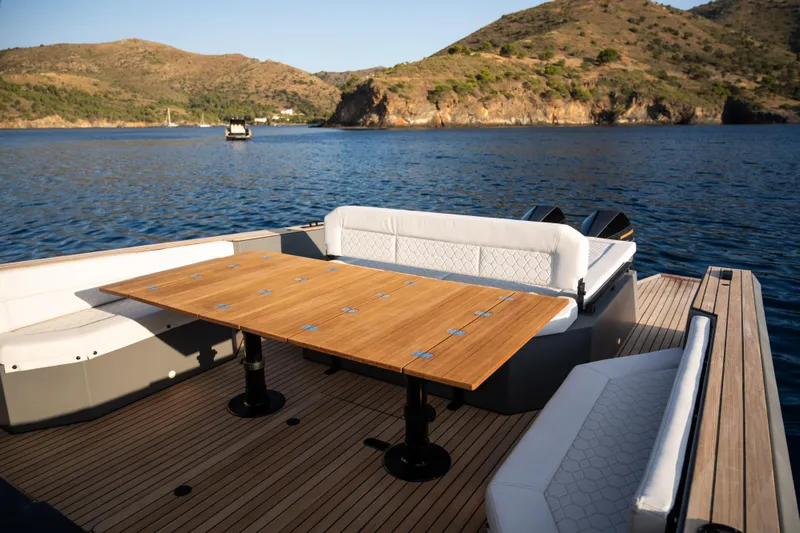 Maxim Yachts | Max43 Race Yacht Photos Pics Luxury Maxim Yachts 43, 2025 model, with elegant deck seating and scenic coastal backdrop.