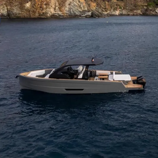 Maxim Yachts | Max43 Race Yacht Photos Pics 2025 Maxim Yachts 43 cruising on serene waters near rocky coastline.