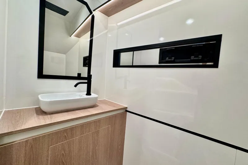 Maxim Yachts | Max43 Race Yacht Photos Pics Modern bathroom interior of 2025 Maxim Yachts 43 Race, featuring sleek sink and mirror design.