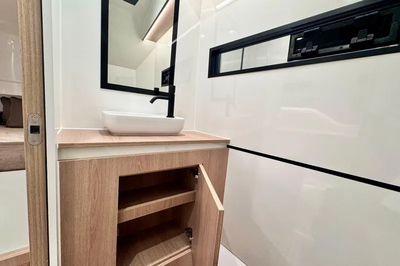 Maxim Yachts | Max43 Race Yacht Photos Pics Modern bathroom interior of 2025 Maxim Yachts 43 Race, featuring sleek sink and wooden cabinetry.