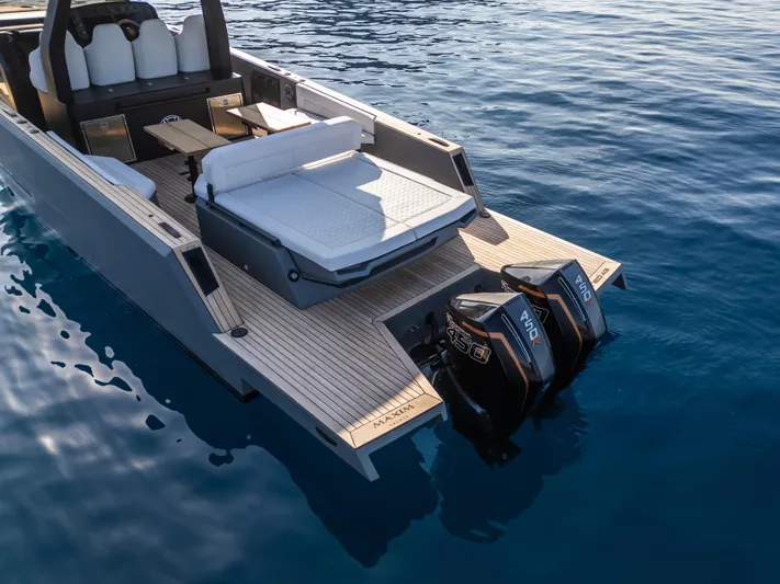 Maxim Yachts | Max43 Race Yacht Photos Pics 2025 Maxim Yachts 43 with dual engines, sleek deck design, on calm blue water.