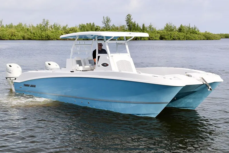  Yacht Photos Pics Manufacturer Provided Image: 2021 Twin Vee 280 CC GF boat cruising on a calm lake.