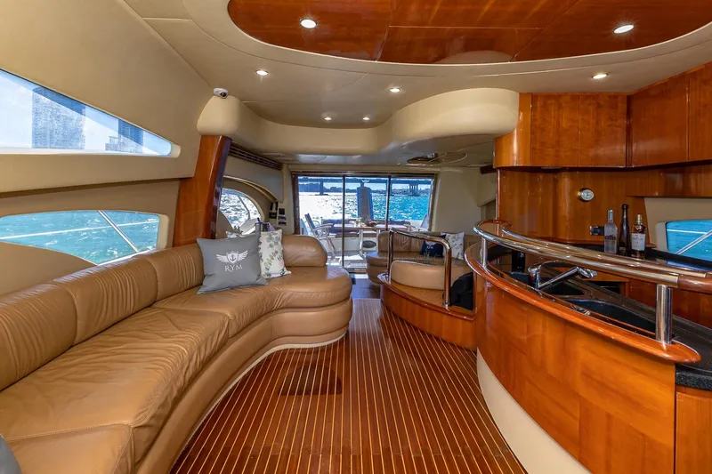 L’chaim Yacht Photos Pics Luxurious interior of 2007 Azimut Fly 62 yacht with elegant wood finishes and leather seating.