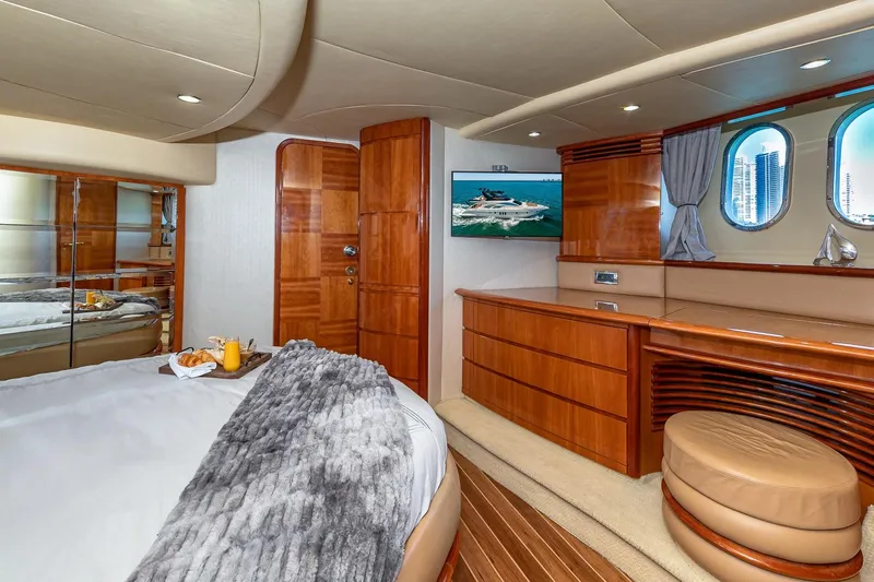 L’chaim Yacht Photos Pics Luxurious 2007 Azimut Fly 62 yacht bedroom with elegant wood finishes and cozy decor.