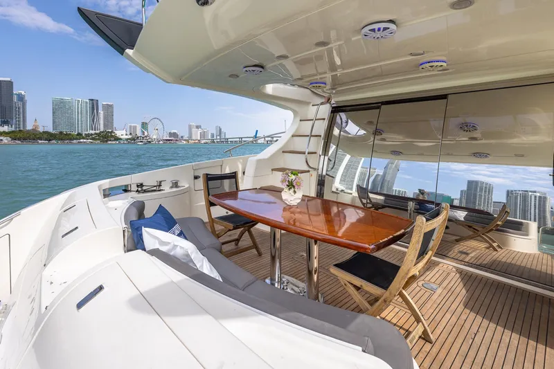 L’chaim Yacht Photos Pics Luxurious 2007 Azimut Fly 62 yacht with elegant deck, city skyline view.