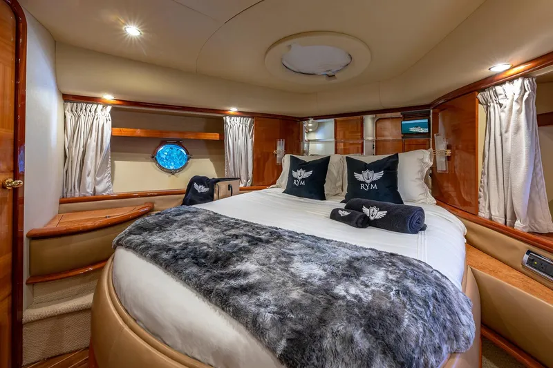 L’chaim Yacht Photos Pics Luxurious bedroom interior of 2007 Azimut Fly 62 yacht with elegant bedding and wood accents.