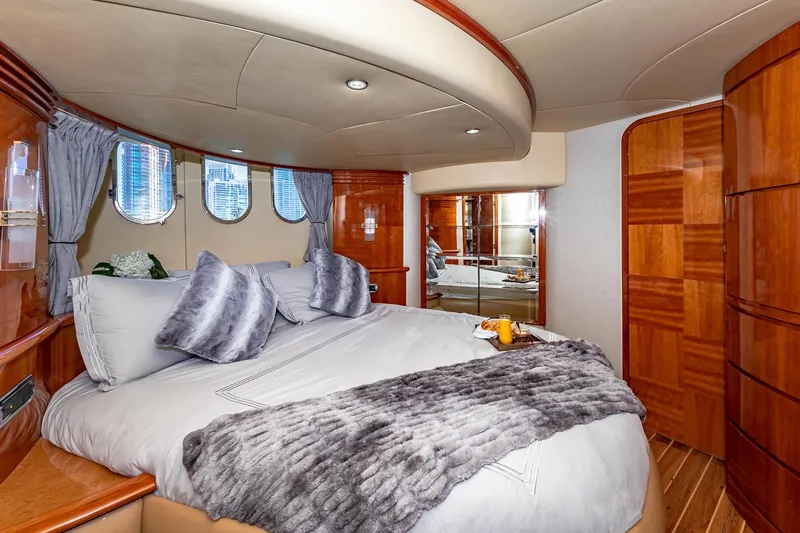 L’chaim Yacht Photos Pics Luxurious bedroom interior of 2007 Azimut Fly 62 yacht with plush bedding and elegant wood finishes.