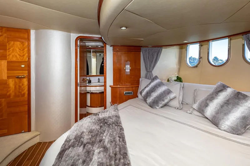 L’chaim Yacht Photos Pics Luxurious 2007 Azimut Fly 62 yacht bedroom with elegant wood finishes and plush bedding.