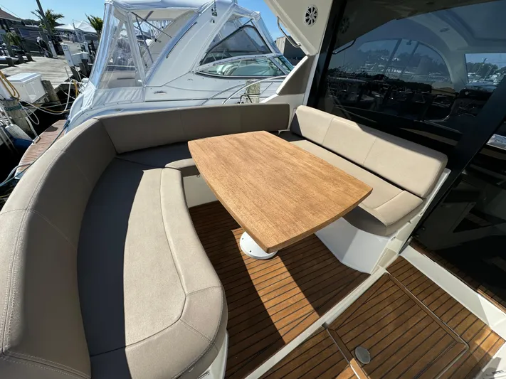  Yacht Photos Pics Luxurious 2012 Prestige 440 S yacht with elegant seating and wooden table on deck.