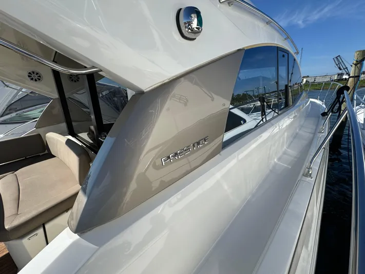  Yacht Photos Pics Prestige 440 S yacht, 2012 model, sleek design, docked under clear blue sky.
