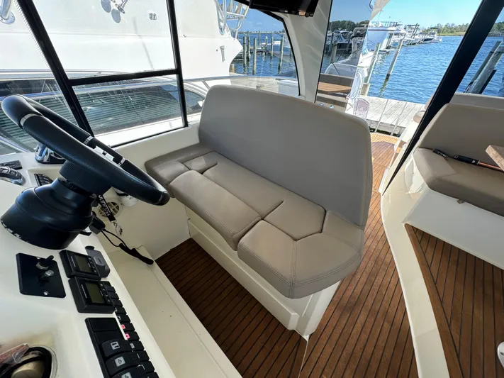  Yacht Photos Pics Interior of 2012 Prestige 440 S yacht with helm seat and wooden flooring.