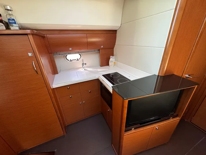  Yacht Photos Pics Compact kitchen in 2012 Prestige 440 S yacht with modern appliances and wood cabinetry.