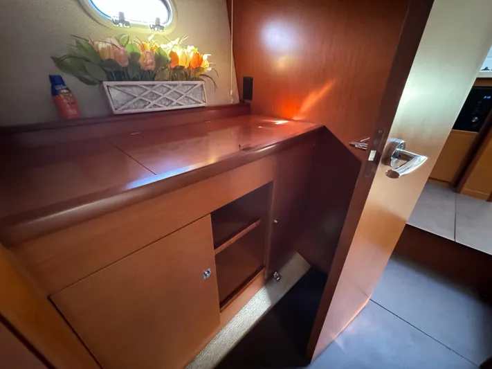  Yacht Photos Pics Interior of 2012 Prestige 440 S yacht with wooden cabinetry and floral decor.