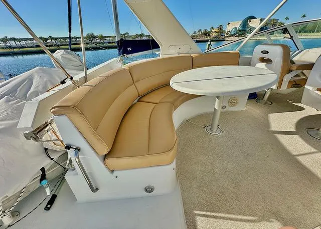  Yacht Photos Pics 1999 Carver 450 Voyager Pilothouse yacht with tan seating and round table on deck.