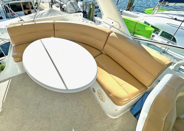  Yacht Photos Pics 1999 Carver 450 Voyager Pilothouse yacht with tan seating and round table on deck.