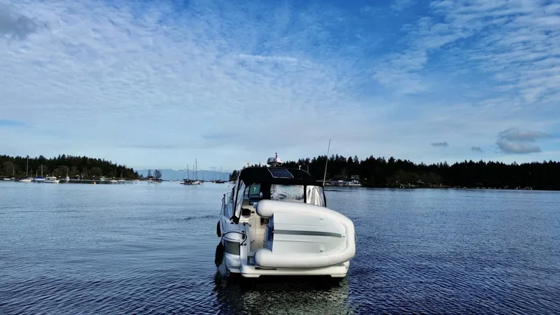  Yacht Photos Pics 2006 Cruisers Yachts 340 Express on calm water under a blue sky.