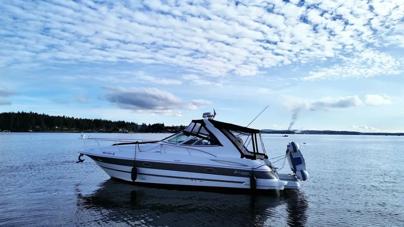  Yacht Photos Pics 2006 Cruisers Yachts 340 Express on calm water under a partly cloudy sky.