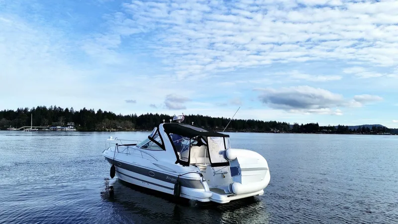  Yacht Photos Pics 2006 Cruisers Yachts 340 Express on serene lake under blue sky.