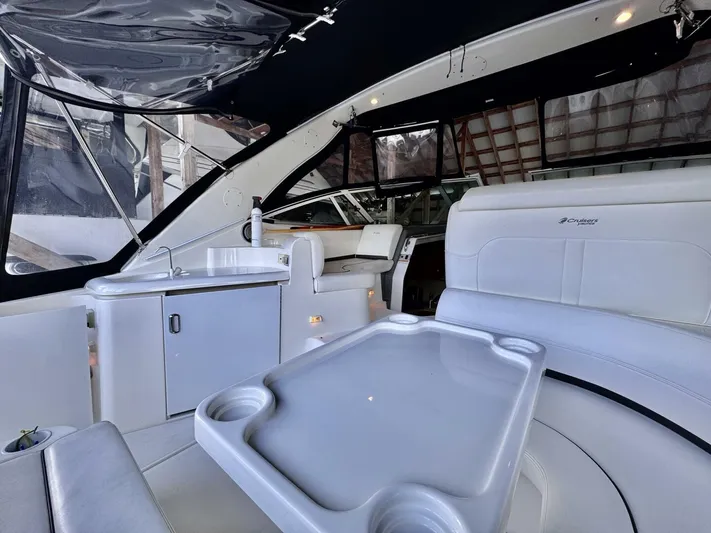  Yacht Photos Pics 2006 Cruisers Yachts 340 Express interior with white seating and table, showcasing luxury design.