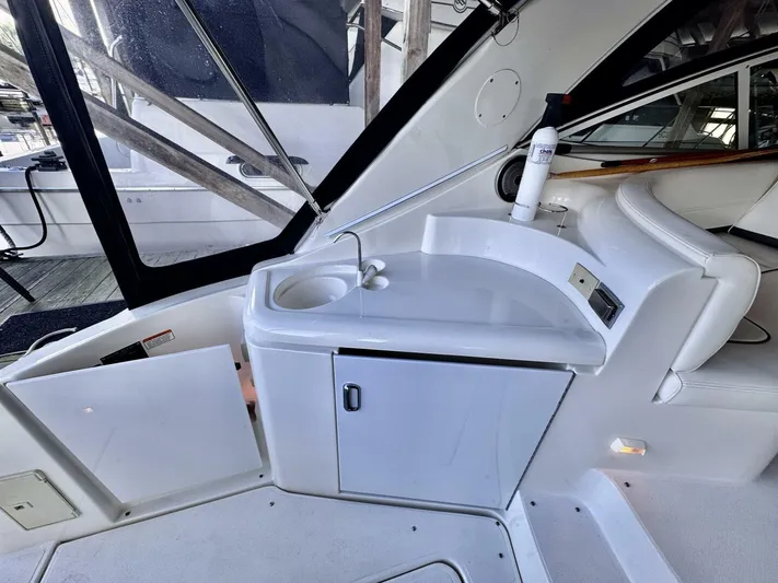  Yacht Photos Pics 2006 Cruisers Yachts 340 Express interior with sink and seating area.