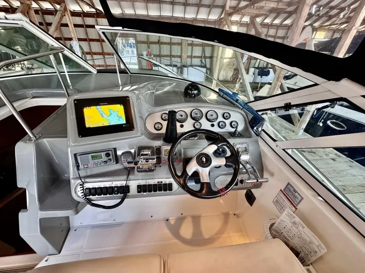  Yacht Photos Pics 2006 Cruisers Yachts 340 Express helm with navigation system and control panel.