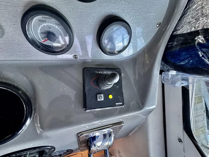  Yacht Photos Pics Control panel of 2006 Cruisers Yachts 340 Express with thruster joystick and temperature gauge.