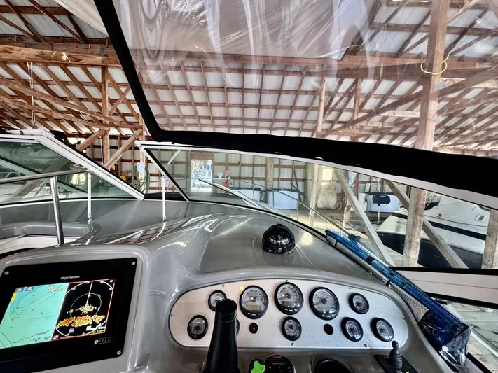  Yacht Photos Pics 2006 Cruisers Yachts 340 Express dashboard with navigation system in a boat storage facility.