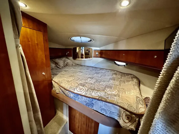  Yacht Photos Pics Cozy cabin interior of 2006 Cruisers Yachts 340 Express with elegant wood finish and bedding.
