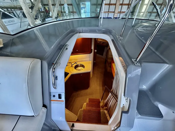  Yacht Photos Pics 2006 Cruisers Yachts 340 Express interior view with stairs and kitchenette.