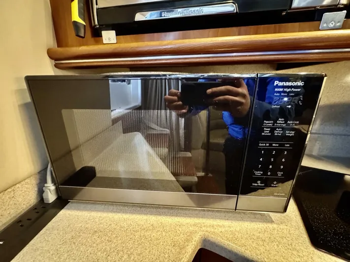 Yacht Photos Pics Microwave in 2006 Cruisers Yachts 340 Express kitchen area, featuring Panasonic high-power model.