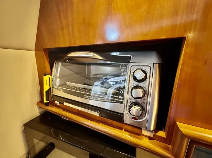  Yacht Photos Pics Toaster oven in 2006 Cruisers Yachts 340 Express kitchen with wooden cabinetry.