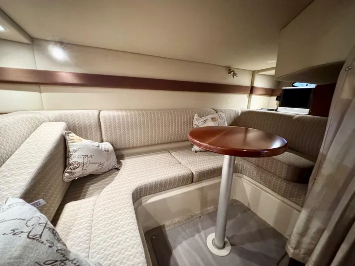  Yacht Photos Pics 2006 Cruisers Yachts 340 Express interior with cozy seating and wooden table.