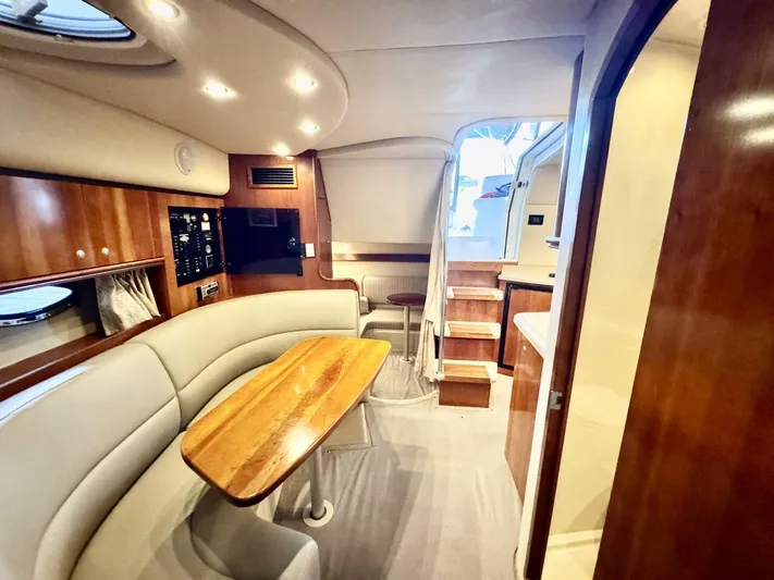  Yacht Photos Pics 2006 Cruisers Yachts 340 Express interior with wood accents and cozy seating area.