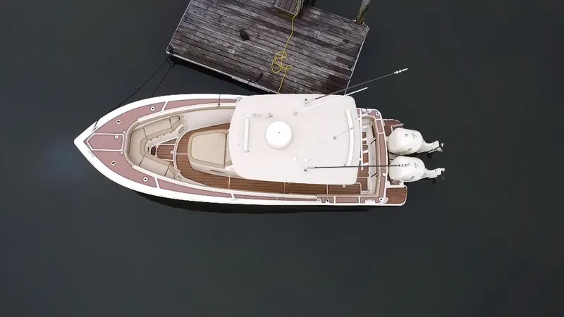  Yacht Photos Pics Aerial view of 2015 Scout 300 LXF boat docked at a pier.