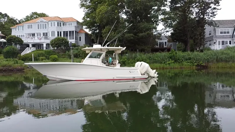  Yacht Photos Pics 2015 Scout 300 LXF boat on calm water near luxury homes.