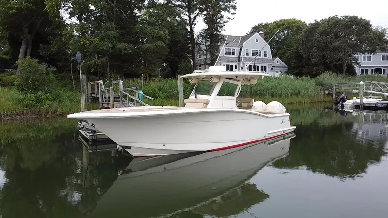  Yacht Photos Pics 2015 Scout 300 LXF boat docked near waterfront homes.