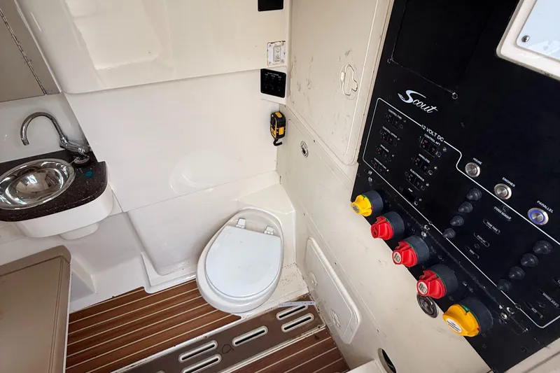  Yacht Photos Pics 2015 Scout 300 LXF boat interior with toilet, sink, and control panel.
