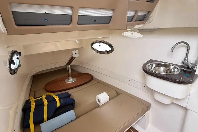  Yacht Photos Pics 2015 Scout 300 LXF cabin interior with sink, seating, and life jackets.
