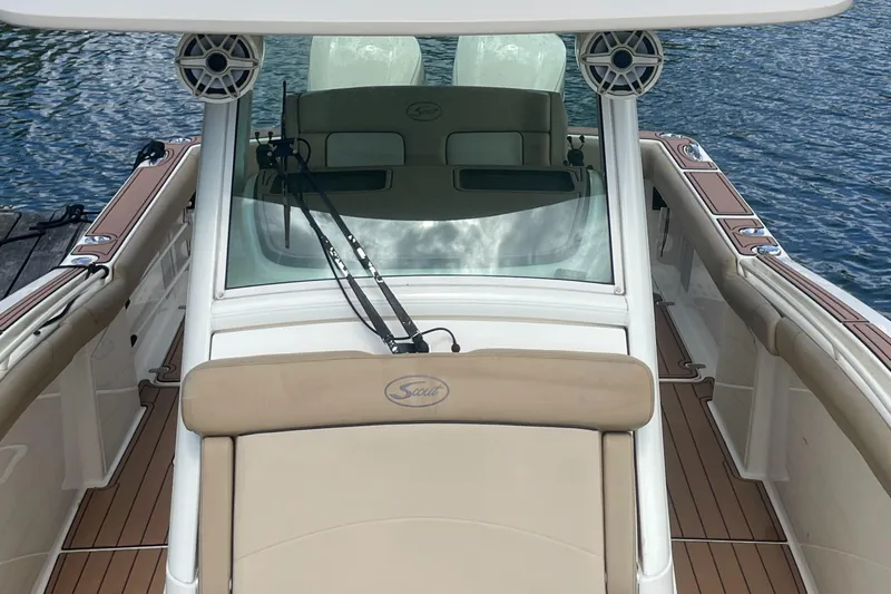  Yacht Photos Pics 2015 Scout 300 LXF boat interior with tan seating and wood accents on water.