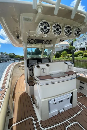  Yacht Photos Pics 2015 Scout 300 LXF boat interior with helm, speakers, and wooden deck.