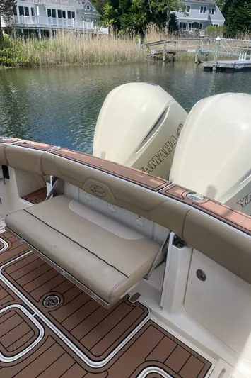  Yacht Photos Pics 2015 Scout 300 LXF boat with Yamaha engines, docked near waterfront homes.