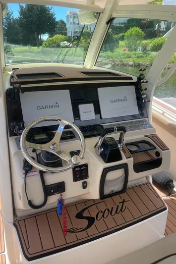  Yacht Photos Pics 2015 Scout 300 LXF boat dashboard with Garmin navigation displays and steering wheel.
